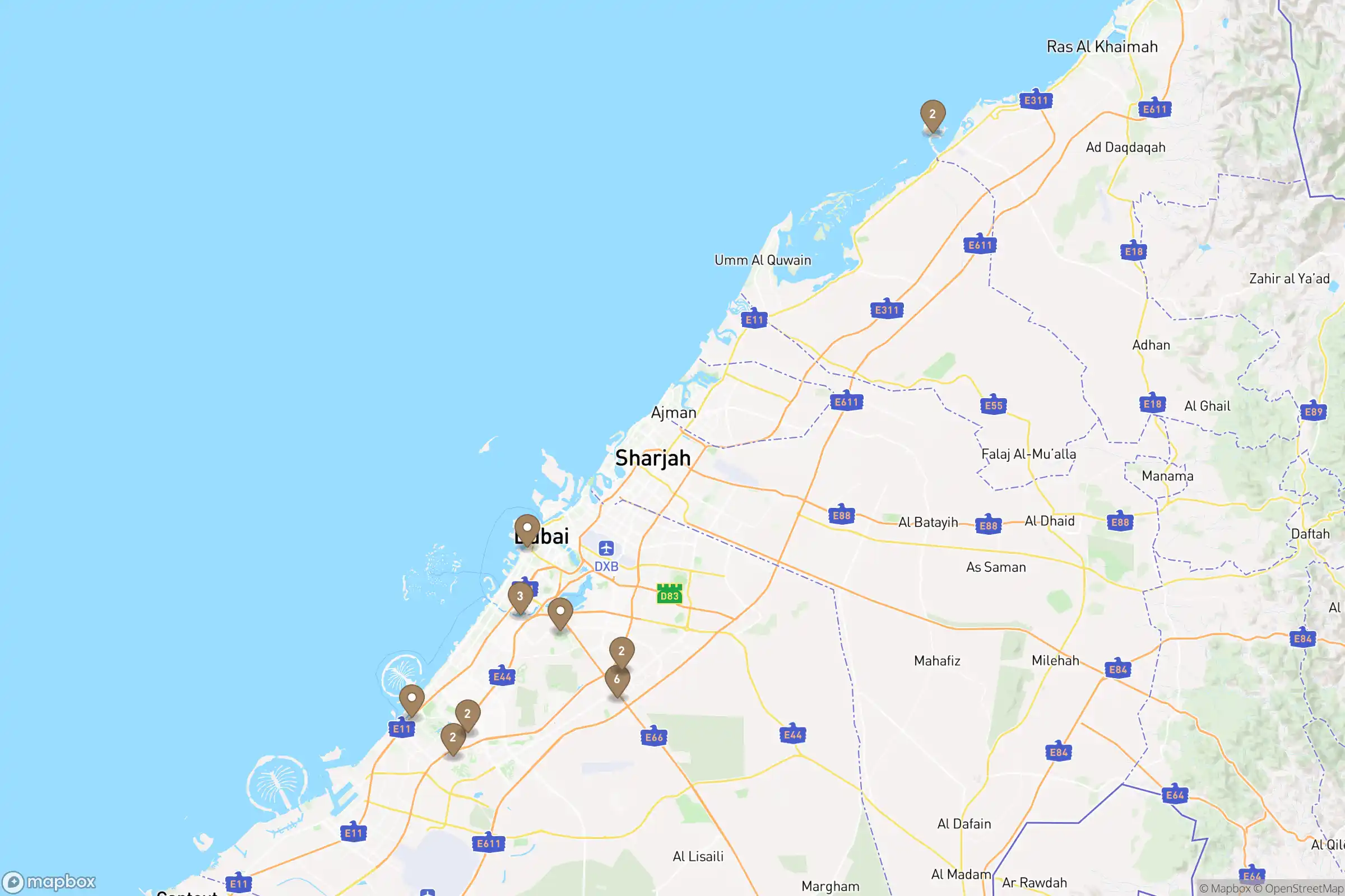Map of Dubai and Ras Al Khaimah with 12 bronze markers on the communities where ProEstate holds inventory.